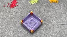 there is a purple kite on the ground next to other colorful objects that are scattered around it