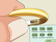 a close up of a person holding a gold ring with numbers on the front and back