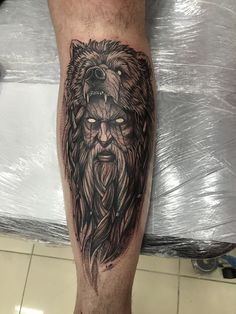 a man's leg with a lion tattoo on it and his head in the middle