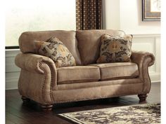 a living room with a couch, rug and window