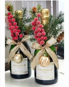 two bottles of champagne with christmas decorations on them