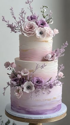 a multi layer cake with flowers on top