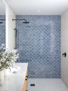 a bathroom with blue and white tiles on the walls