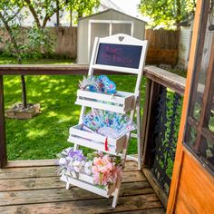 a white chair sitting on top of a wooden deck next to a sign that says please tea party