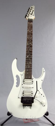 an electric guitar is shown on a stand