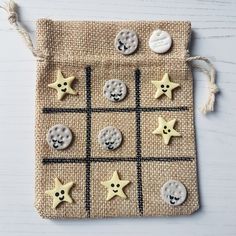 a cloth bag with buttons and stars on it