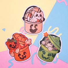 three stickers depicting cats in buckets and pumpkins