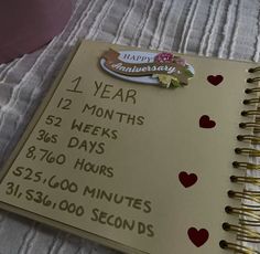 a wedding guest book with the date and time printed on it, sitting on a bed