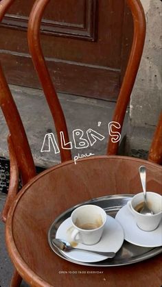 two cups and saucers on a wooden table