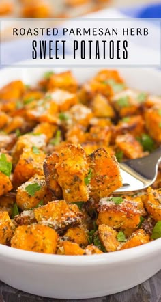 roasted parmesan herb sweet potatoes in a white bowl with a serving spoon on the side