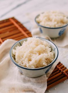 two bowls filled with rice on top of a table