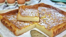 four pieces of cake sitting on top of a piece of wax paper next to eggs