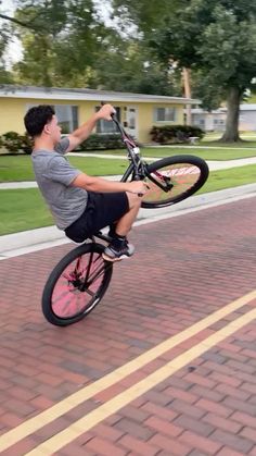 a young man is doing tricks on his bike