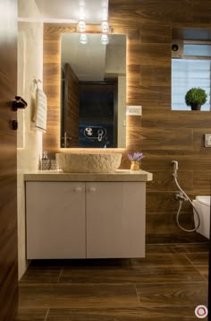 a bathroom with a sink, toilet and mirror on the wall next to each other