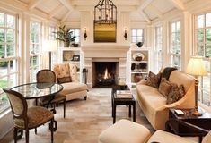 a living room filled with furniture and a fire place in the middle of a room