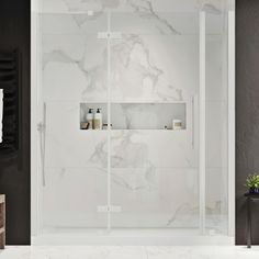 a white bathroom with black accents and marble tile walls, along with a walk in shower