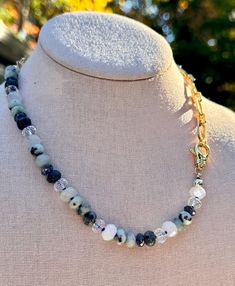 This stunning one-of-a-kind necklace beautifully blends the elegance of natural gemstones with the shine of 14k gold-filled chain. Measuring approximately 17 inches in length, half of the necklace features vibrant, untreated gemstones -- Phantom Quartz, Moonstone, Larvikite, Kiwi Jasper, Jade, and Rock Quartz -- all hand-knotted on delicate blue silk thread. The other half consists of a chunky 14k gold-filled oval chain, creating a balanced and unique design. The necklace is finished with a large, easy-to-use 14k gold-filled lobster clasp, ensuring both security and style. This necklace is versatile enough to complement any outfit, whether you're dressing up or adding a touch of elegance to everyday wear. Since each gemstone is natural and untreated, expect subtle variations in color, addi Kiwi Jasper, Phantom Quartz, The Other Half, Other Half, Necklace Beaded, Blue Silk, Silk Thread, Gold Filled Chain, Jewelry Care