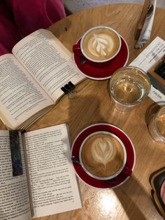 two cups of coffee and an open book on a table