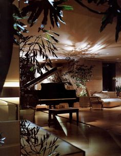 a living room filled with furniture and a grand piano