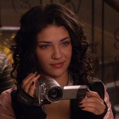 a woman holding up a camera in front of her face