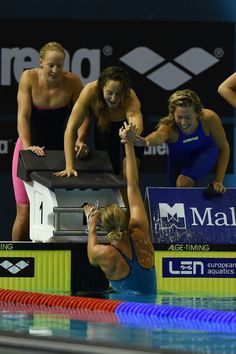 the women are getting ready to swim in the pool