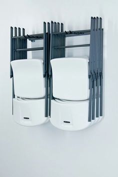 three white chairs are stacked on top of each other