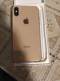 an iphone in its box sitting on top of a table with it's lid open