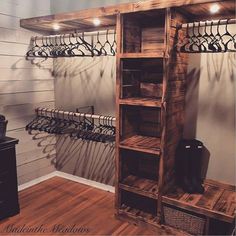 a wooden shelf with several pairs of shoes hanging from it's sides and some hangers on the wall