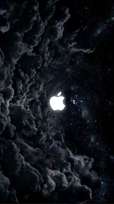 an apple logo in the sky with clouds and stars around it, as seen from space