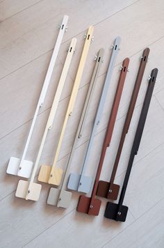 five different types of door handles on the floor with white and brown trimmings