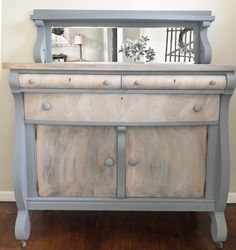 an old dresser is painted gray and white