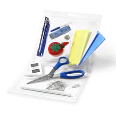 scissors and other items are in a clear box on a white surface with clippings