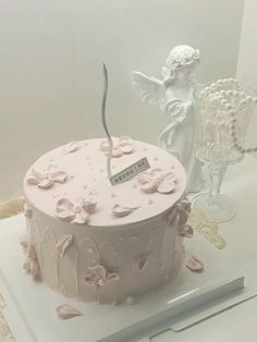 there is a pink cake with flowers on it