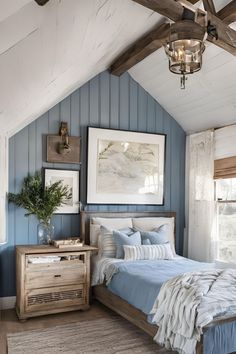 a bedroom with blue walls and wooden beams