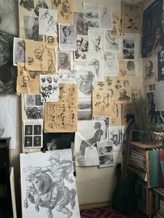 a room with many drawings and pictures on the wall