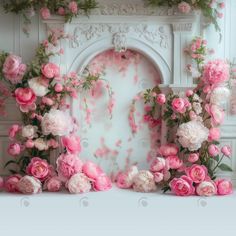 pink and white flowers are arranged in front of a fireplace