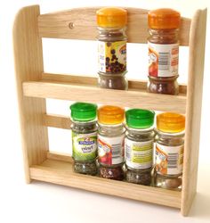 a wooden spice rack with jars and spices