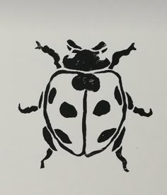 a black and white drawing of a lady bug