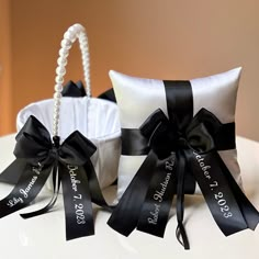 two white and black wedding baskets with ribbons