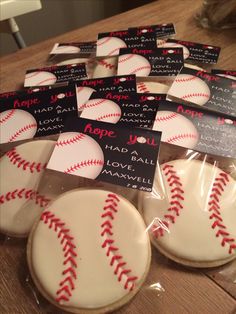 several decorated cookies in plastic wrappers with baseball designs on the front and back of them