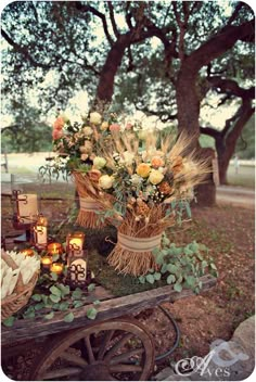 an old wagon with flowers and candles on it