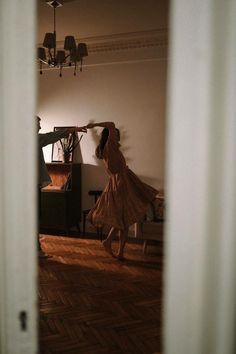 a woman in a dress is dancing on the floor