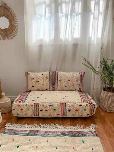 a living room with a couch and rugs on the floor