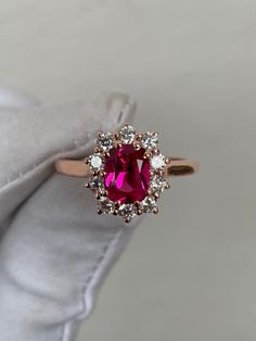 a close up of a ring with a red stone in it on a white napkin