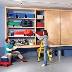 a man and woman working on shelves in a garage