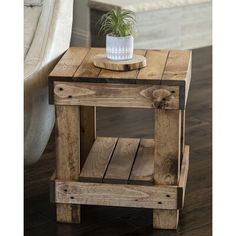 a small wooden table with a potted plant on top