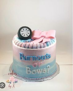 a birthday cake decorated with a wheel and bow on it's top is shown