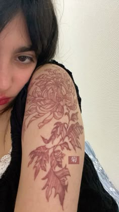 a woman with a flower tattoo on her arm