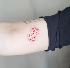 a person with a red tattoo on their arm has four dices drawn on it