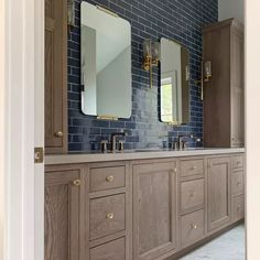 a bathroom with two sinks and mirrors in it